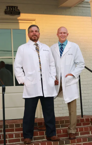 Scott and Forrest Harris, DMDs, in front of family dental office